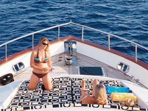 82 euro women laying out on bow
